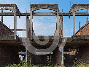 Abandoned building by front perspective of unfinished house with degenerate structure