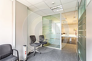 Abandoned building of an insolvent owner with an interior in a simple office style. Offices, left and right, with glass