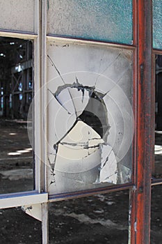 Broken and cracked industrial windows in metal frames photo