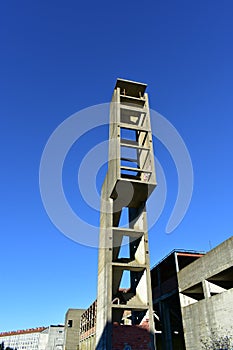 Abandoned building structure. Tower stairs in ruins. Sunny day.