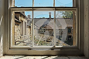 Abandoned building view through a broken window