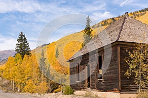 Abandoned building among the yellow aspen trees in the Sun Juan Mountains of Colorado