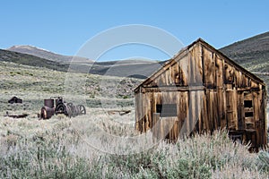 Abandoned buildings at Bodie Ghost Town in California and mining equipment