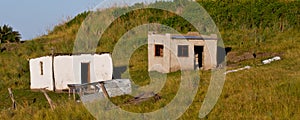 Abandoned buildings on hillside