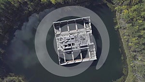 Abandoned buildings in pond. Top view