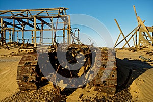 Abandoned bulldozer and derelict buildings photo