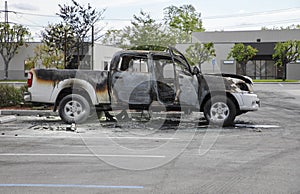 Abandoned burned truck with open doors. Car caught on fire