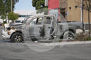 Abandoned burned truck in a parking lot
