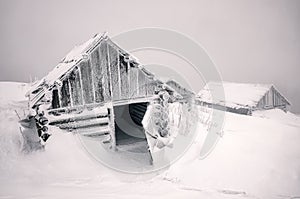 Abandoned cabin with opened door in winter