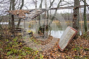 abandoned camp fishermen hunters on the shore of the lake in the autumn forest