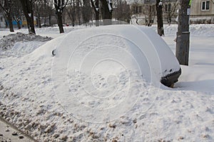 Abandoned car brought by snow on a roadside