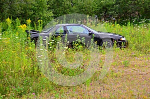 Abandoned car in field