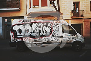 Abandoned car slovenly painted with graffiti