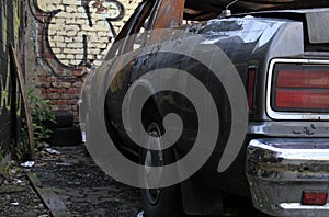 Abandoned car wreck in backstreet