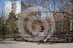 Abandoned carousel at an amusement park in the center of the city of Pripyat, the Chernobyl disaster, the exclusion zone, a ghost