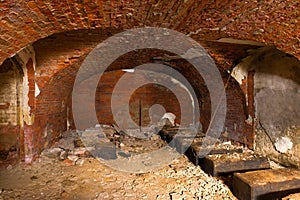 Abandoned casemate for storing artillery shells of the old naval fort Zverev. Kronstadt, Russia photo