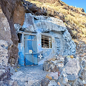 Abandoned cave house with a wooden blue door close to Lol Llanos, La Palma on the Canary Islands. Rustic broken and aged