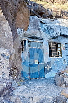 Abandoned cave house with a wooden blue door close to Lol Llanos, La Palma, Canary Islands. Rustic, vintage, broken and