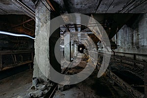 Abandoned cement and concrete factory. Old conveyor and rusty hoppers