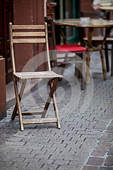 Abandoned chairs and tables in front of a restaurant