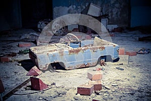 Abandoned children car toy in decaying city of Pripyat photo