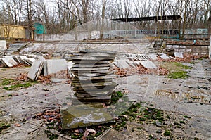 Abandoned children`s camp. An old abandoned and ruined pool. Old pool tiles and steps.