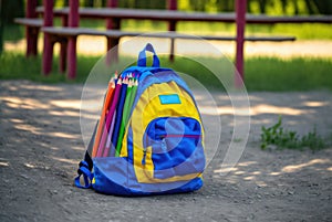 Abandoned childrens backpack in an empty playground