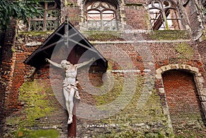 Abandoned church with Jesus figure on rustic brick wall. Old place for worshipers