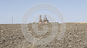 An abandoned Church in the middle of a plowed field
