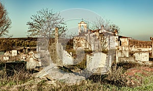 Abandoned church ruin and cemetery overgrown landscape