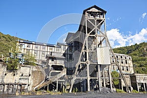 Abandoned coal factory. Industrial rusted machinery. Polluted landscape. Energy