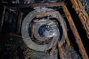 Abandoned coal mine with rotten collapsed wooden miner stands. Old derelict coal development