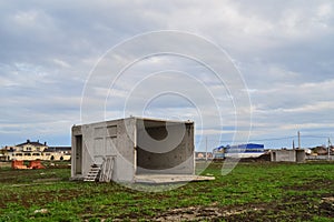 An abandoned concrete box in the field is used as a house