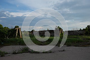 Abandoned concrete silage storage facility. Evening landscape. Abandoned farm buildings