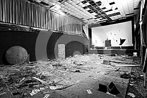 Abandoned and damaged interior of a movie theatre with stage