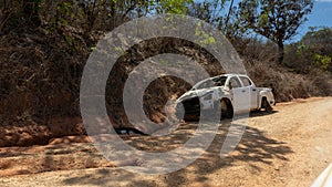 Abandoned and destroyed car in Mocimboa da Praia in Cabo Delgado, Mozambique photo