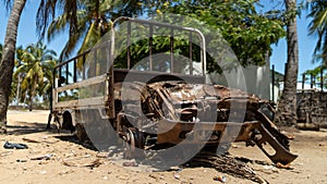 Abandoned and destroyed car in Mocimboa da Praia in Cabo Delgado, Mozambique photo