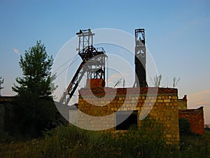 Abandoned destroyed equipment of a salt mine in a field