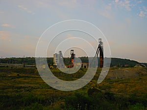 Abandoned destroyed equipment of a salt mine in a field