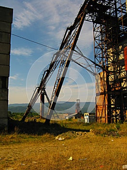 Abandoned destroyed equipment of a salt mine in a field