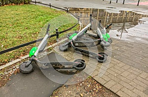 An abandoned dirty Lime scooters lie on the ground of a street in Wroclaw, Poland