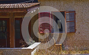 Abandoned empty house with red shutters in Binyamina in northwestern Israel.