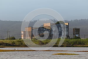 Abandoned Factory Building On Estuary Riverbank