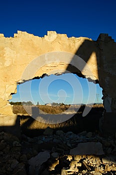 Abandoned factory, hole in the wall with landscape