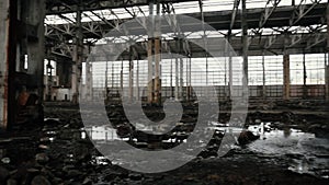 Abandoned factory inside with a roof leaking from the rain, toned