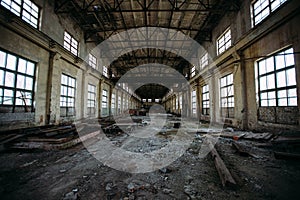 Abandoned factory. Large empty industrial hall with garbage