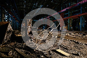 Abandoned factory. Large empty ruined industrial hall with remnant of equipment at night