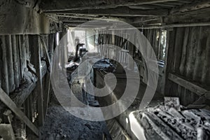 Abandoned factory. Old dusty band conveyer in old corridor of reinforced concrete plant