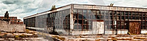 Abandoned factory warehouse with broken windows