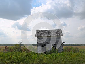 Abandoned Farm House with clouds on Minnesota Prairie